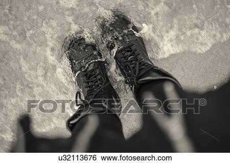 High angle view of young woman in laced boots in sea View Large Photo Image Stock Photograph - High angle view of young woman in laced boots in sea. Fotosearch