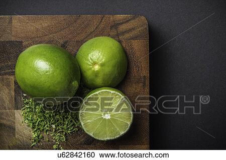 Stock Image - Ingredient for making green curry paste - lime. Fotosearch