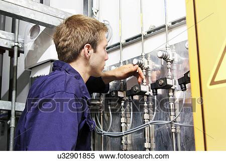 Male electrician checking valves on power cables in factory View Large Photo Image Stock Photography - Male electrician checking valves on power cables in factory. Fotosearch