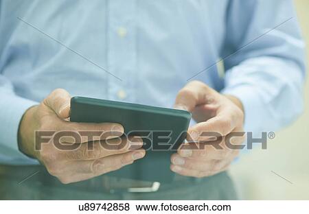 Male hands holding digital tablet View Large Photo Image Stock Photo - Male hands holding digital tablet. Fotosearch