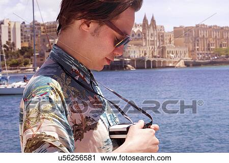 Man checking his camera, Ta' Xbiex harbor, Gzira, Malta View Large Photo Image Stock Image - Man checking his camera, Ta' Xbiex harbor, Gzira, Malta. Fotosearch