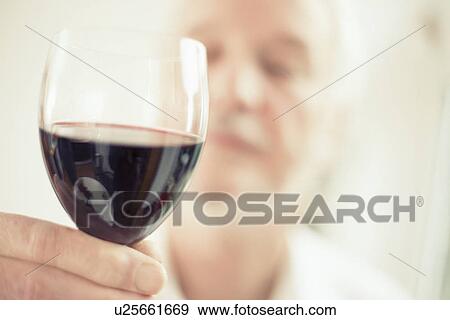 Man holding red wine, close up View Large Photo Image Stock Photo - Man holding red wine, close up. Fotosearch
