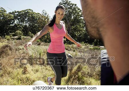 Man looking at female jogger balancing View Large Photo Image Stock Photo - Man looking at female jogger balancing. Fotosearch