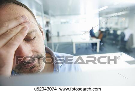 Man thinking, people in background View Large Photo Image Picture - Man thinking, people in background. Fotosearch