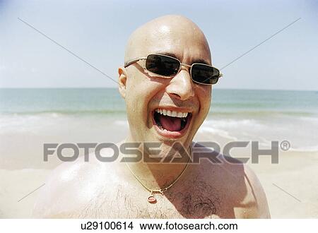 Mature man on beach with mouth open, smiling View Large Photo Image Picture - Mature man on beach with mouth open, smiling. Fotosearch