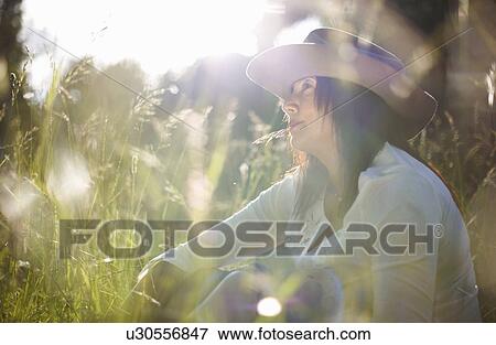 Mature woman in cowboy hat with blade of grass in her mouth View Large Photo Image Stock Photo - Mature woman in cowboy hat with blade of grass in her mouth. Fotosearch
