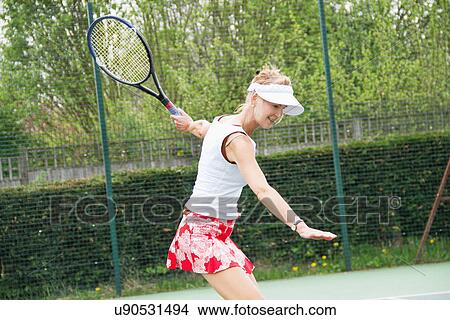Mature woman playing tennis View Large Photo Image Picture - Mature woman playing tennis. Fotosearch