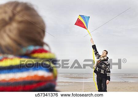 Mid adult man and son with kite on beach, Bloemendaal aan Zee, Netherlands View Large Photo Image Stock Photograph - Mid adult man and son with kite on beach, Bloemendaal aan Zee, Netherlands. Fotosearch