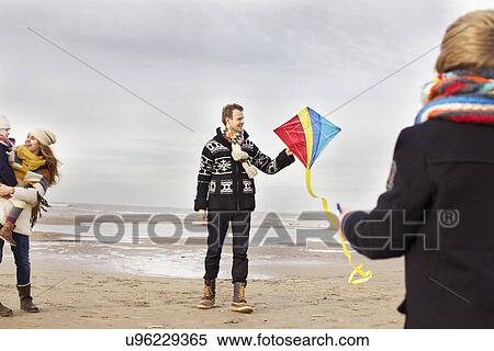 Mid adult parents with son and daughter playing with kite on beach, Bloemendaal aan Zee, Netherlands View Large Photo Image Stock Photography - Mid adult parents with son and daughter playing with kite on beach, Bloemendaal aan Zee, Netherlands. Fotosearch