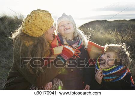 Mid adult woman in sand dunes with son and daughter wrapped in blanket View Large Photo Image Stock Image - Mid adult woman in sand dunes with son and daughter wrapped in blanket. Fotosearch