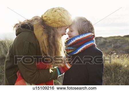 Stock Photograph - Mid adult woman with son at coast. Fotosearch