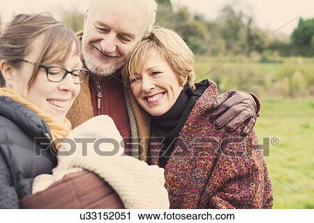 Mother holding baby son, with grandparents View Large Photo Image Stock Image - Mother holding baby son, with grandparents. Fotosearch