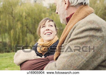 Picture - Mother with baby and grandfather smiling. Fotosearch