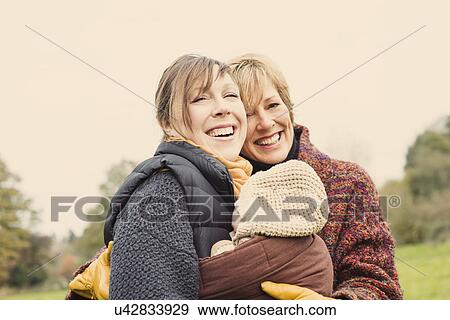 Mother with baby and grandmother laughing View Large Photo Image Stock Photo - Mother with baby and grandmother laughing. Fotosearch