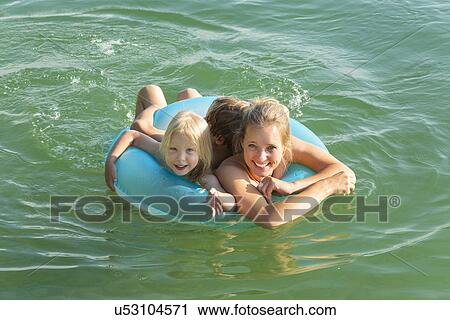 Mother with daughter and son in inflatable ring, Lake Starnberg, Bavaria, Germany View Large Photo Image Stock Image - Mother with daughter and son in inflatable ring, Lake Starnberg, Bavaria, Germany. Fotosearch