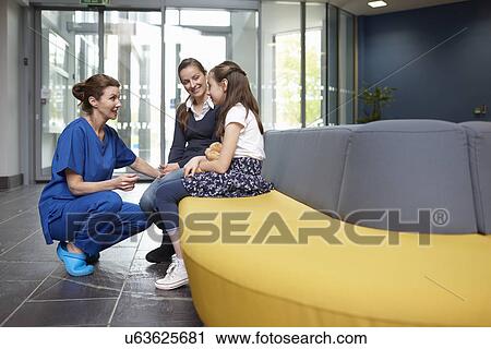 Nurse speaking to girl in hospital waiting room View Large Photo Image Stock Image - Nurse speaking to girl in hospital waiting room. Fotosearch