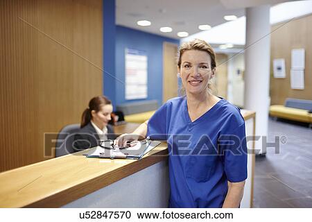 Nurse standing in hospital waiting room View Large Photo Image Stock Image - Nurse standing in hospital waiting room. Fotosearch