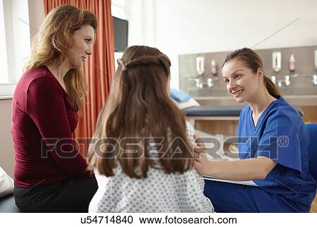 Stock Image - Nurse talking to patient and mother. Fotosearch
