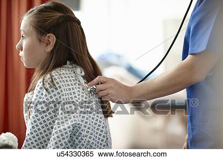 Nurse using stethoscope on girl View Large Photo Image Stock Photography - Nurse using stethoscope on girl. Fotosearch