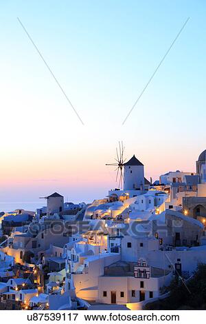 Stock Photo - Oia town and windmill at dusk, Santorini, Cyclades Islands, Greece. Fotosearch