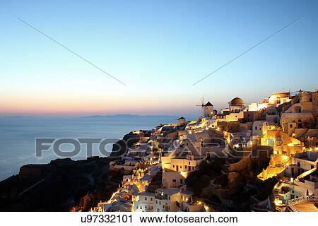 Stock Image - Oia town at sunset, Santorini, Cyclades Islands, Greece. Fotosearch