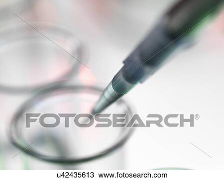 Pipette dripping liquid into test tube View Large Photo Image Stock Image - Pipette dripping liquid into test tube. Fotosearch
