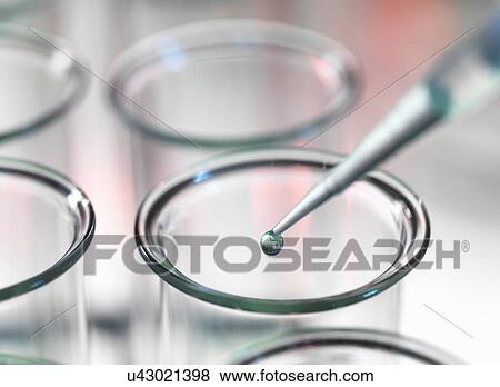 Pipette dripping liquid into test tube View Large Photo Image Stock Photo - Pipette dripping liquid into test tube. Fotosearch
