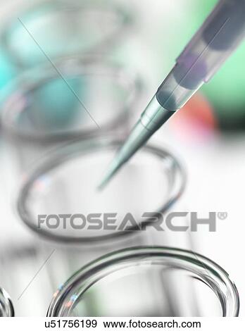 Pipette dripping liquid into test tube View Large Photo Image Stock Photo - Pipette dripping liquid into test tube. Fotosearch