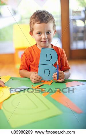 Portrait of boy with letter B at nursery school View Large Photo Image Stock Photo - Portrait of boy with letter B at nursery school. Fotosearch