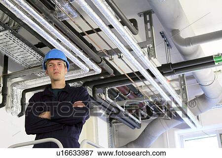 Portrait of confident male engineer in factory View Large Photo Image Stock Photo - Portrait of confident male engineer in factory. Fotosearch