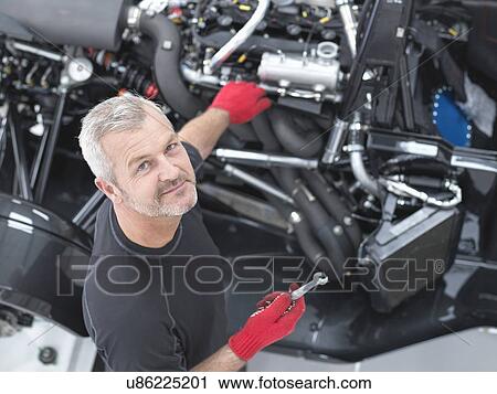 Portrait of engineer assembling supercar in sports car factory, high angle view View Large Photo Image Stock Image - Portrait of engineer assembling supercar in sports car factory, high angle view. Fotosearch