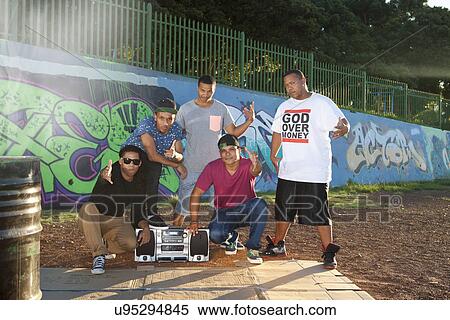 Stock Photography - Portrait of five male hip hop dancers in park at dusk. Fotosearch