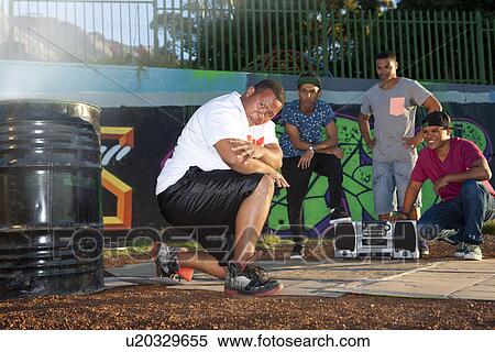 Portrait of male hip hop dancers in park at dusk View Large Photo Image Stock Photography - Portrait of male hip hop dancers in park at dusk. Fotosearch