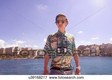 Stock Photo - Portrait of man with camera, Ta' Xbiex harbor, Gzira, Malta. Fotosearch
