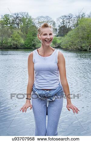 Stock Photo - Portrait of mature woman exercising in park. Fotosearch
