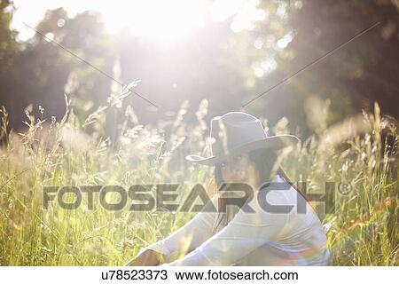 Portrait of mature woman in long grass wearing cowboy hat View Large Photo Image Stock Image - Portrait of mature woman in long grass wearing cowboy hat. Fotosearch