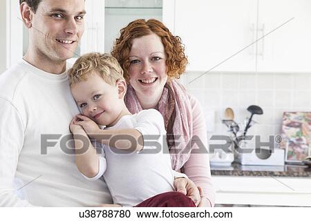 Stock Image - Portrait of mid adult couple and four year old son. Fotosearch