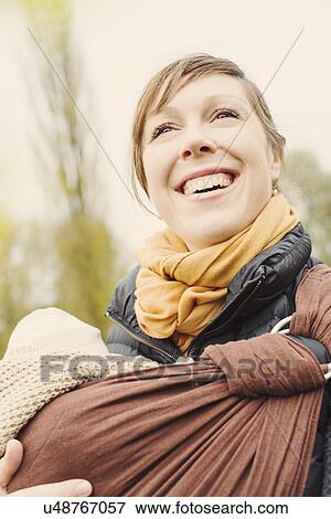 Stock Photo - Portrait of mother carrying baby son. Fotosearch