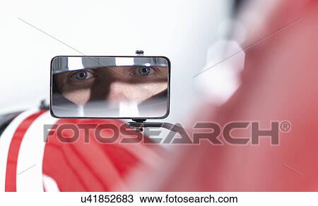 Portrait of racing car driver reflected in wing mirror of supercar View Large Photo Image Stock Image - Portrait of racing car driver reflected in wing mirror of supercar. Fotosearch