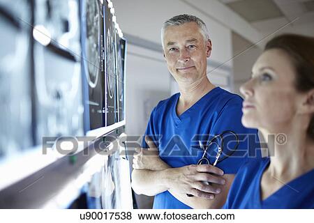 Stock Photo - Portrait of radiologists with brain scans. Fotosearch
