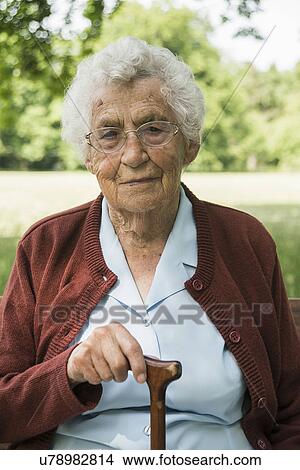 Portrait of senior woman, holding walking stick View Large Photo Image Picture - Portrait of senior woman, holding walking stick. Fotosearch