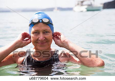 Picture - Portrait of senior woman swimmer in sea. Fotosearch