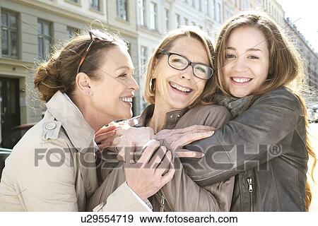 Stock Photo - Portrait of three generation females in the city. Fotosearch