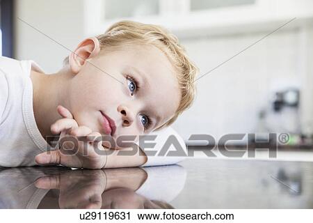 Portrait of three year old boy leaning on kitchen bench View Large Photo Image Stock Image - Portrait of three year old boy leaning on kitchen bench. Fotosearch