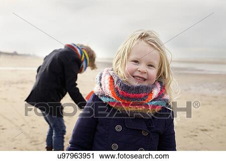 Stock Image - Portrait of three year old girl and brother on beach, Bloemendaal aan Zee, Netherlands. Fotosearch