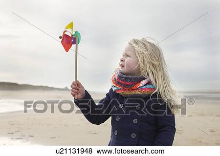 Portrait of three year old girl with paper windmill on beach, Bloemendaal aan Zee, Netherlands View Large Photo Image Stock Photo - Portrait of three year old girl with paper windmill on beach, Bloemendaal aan Zee, Netherlands. Fotosearch