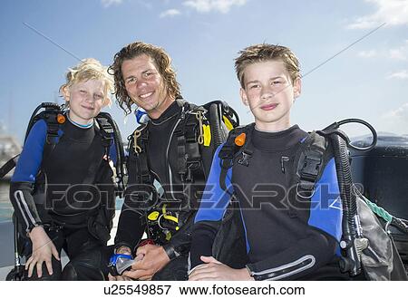 Portrait of two boys with mid adult male scuba diving teacher View Large Photo Image Stock Photo - Portrait of two boys with mid adult male scuba diving teacher. Fotosearch