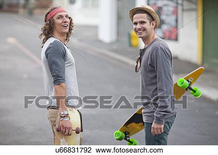 Portrait of two male adult friends with skateboards on city street View Large Photo Image Stock Image - Portrait of two male adult friends with skateboards on city street. Fotosearch