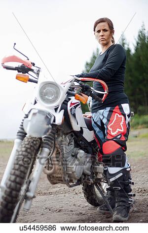 Portrait of young adult female motorcyclist with motorcycle View Large Photo Image Stock Photograph - Portrait of young adult female motorcyclist with motorcycle. Fotosearch