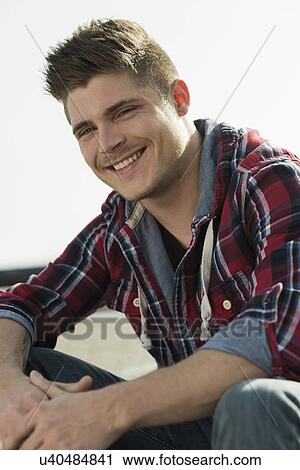 Portrait of young man wearing checked pattern shirt View Large Photo Image Stock Image - Portrait of young man wearing checked pattern shirt. Fotosearch